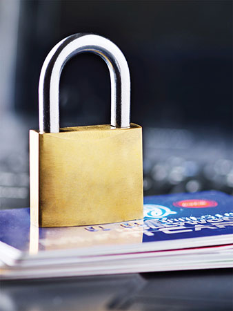 Padlock sitting on a stack of credit cards